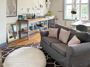 a living room with a couch and a kitchen at Holiday home RONNEBY X in Ronneby