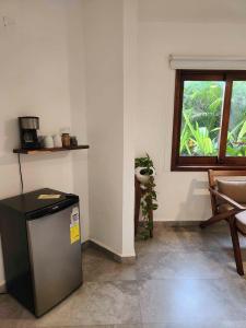 a room with a small refrigerator and a window at Casa Di Giulio in San Francisco