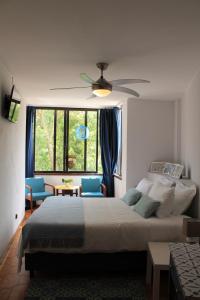 a bedroom with a bed and a ceiling fan at Jardim do Morro Places in Vila Nova de Gaia