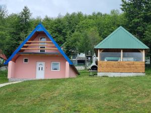 a house and a dog house with a gazebo at Bungalow in Mountain in Žabljak