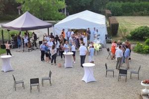 a group of people standing in front of a white tent at Domaine de Beaucamp in Châtelraould-Saint-Louvent