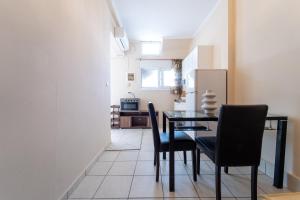 a dining room with a black table and chairs at Stay in calm in Kavála