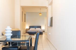 a living room with a bed and a dining table at Stay in calm in Kavála
