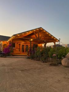 a wooden cabin with lights on top of it at HACIENDA 7 AMORES in El Porvenir