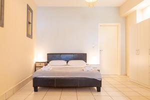 a bedroom with a bed with towels on it at Stay in calm in Kavála