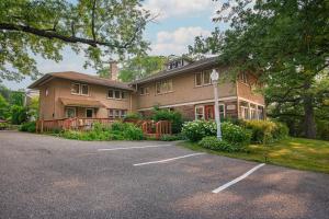 a house with a parking lot in front of it at White Rose Inns & Motel in Wisconsin Dells