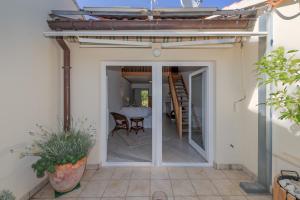 a patio with a table and a dining room at Beachfront apartment Milan, with balcony in Split +40 photos