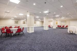 a banquet hall with tables and red chairs at Carousel Resort Hotel and Condominiums in Ocean City +37 photos