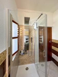 a bathroom with a shower with a glass door at MUSTRA House Zadar - Private Pool & Sauna in Zadar