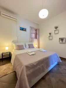 a bedroom with a large bed with two towels on it at MUSTRA House Zadar - Private Pool & Sauna in Zadar +41 photos