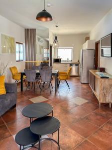 a living room with a couch and a table and chairs at MUSTRA House Zadar - Private Pool & Sauna in Zadar