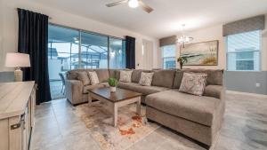 a living room with a couch and a table at 8972 Amelia Downs in Orlando