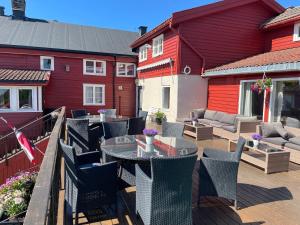 a patio with a table and chairs on a deck at Nordseter Apartments in Lillehammer