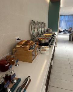 a buffet line with food on it in a restaurant at Fairfield by Marriott San Jose Airport Alajuela in Alajuela City