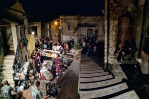 a crowd of people sitting at tables in a building at La Casa in Piazza in Toffia