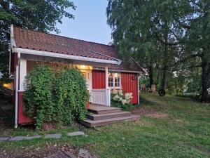 a small red house with a staircase leading to it at Koselig anneks i Heggedal! in Asker