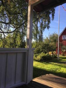 a porch with a white door and a yard at Koselig anneks i Heggedal! in Asker