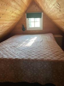 a bedroom with a bed in a attic with a window at Koselig anneks i Heggedal! in Asker