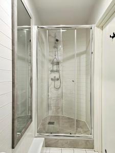 a shower with a glass door in a bathroom at Noclegi Wałbrzych Centrum in Wałbrzych