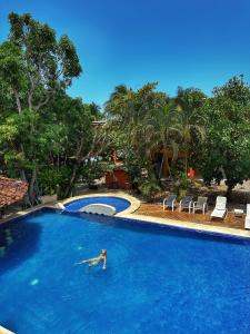 a person swimming in a large swimming pool at Hotel Nany in Brasilito