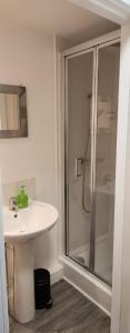 a bathroom with a sink and a shower at White House Ensuite double bedroom in Warrington