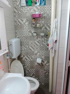 a small bathroom with a toilet and a shower at Apartman Dragana in Pirot +16 photos