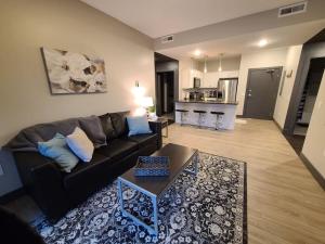 a living room with a couch and a table at 520 Neil Luxury 2 Bedroom in Champaign +9 photos