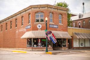 a building on a street corner with a donut shop at Elkader Suites in Elkader