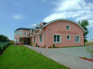 a large pink building with a dome at Penzión Hellene in Piešťany
