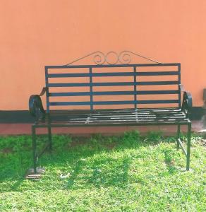 a bench sitting in the grass next to a building at Pacific Homes @milimani court, kakamega in Kakamega