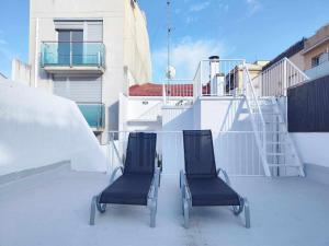 two chairs sitting on the roof of a building at Mazi Apartments Cuba in Mataró