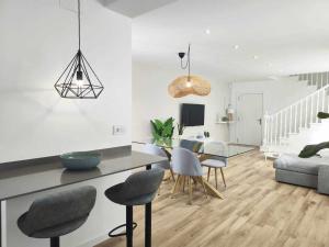 a living room with a dining table and chairs at Mazi Apartments Cuba in Mataró