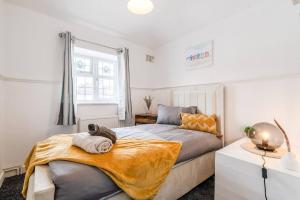 a bedroom with a bed and a window at 3-Bed House Near Lakeside Mall, Onsite Parking in Grays Thurrock