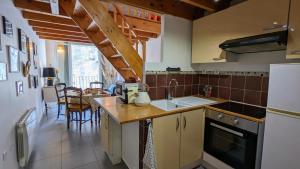 a kitchen with a sink and a counter top at Maison de village avec garage in Aigues-Mortes +11 photos