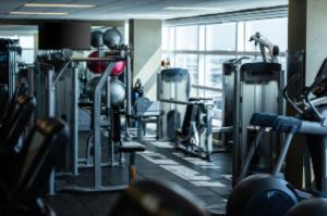 a gym with lots of machines and a large window at Grand Hyatt DFW Airport in Irving