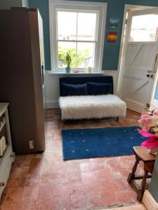 a living room with a door and a blue rug at Maisonette - Halfway down to Swanage or up to Durlston in Swanage