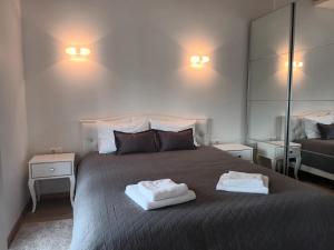 a bedroom with a large bed with two towels on it at GoPalanga in Palanga