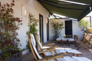 a patio with two chairs and a table at 7 Islas Hotel in Madrid