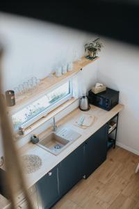 a kitchen counter with a sink and a window at Brzozlove in Nadole