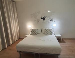 a bedroom with a bed with a map on the wall at Affittacamere Gori 21 in Sarzana