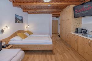a bedroom with a bed and a sink and a tv at Haus Scheiblauer in Tröpolach