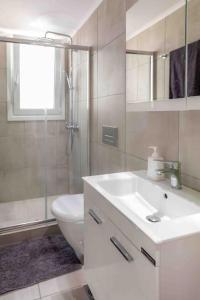 a bathroom with a sink and a toilet and a shower at Luxury cozy appartment in the city center in Rhodes Town +21 photos