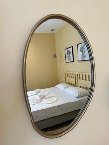 a mirror reflecting a bed in a bedroom at Armenaki in Azolimnos Syros