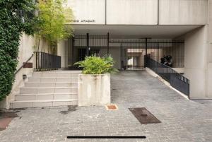 a building with stairs and a plant in front of it at Araçari in São Paulo