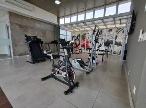 a gym with several exercise bikes in a room at Apto Astúrias Guarujá in Guarujá