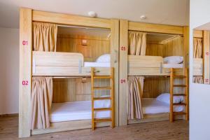 two bunk beds with their doors open in a room at Hostel Zrće All Inclusive- ALL YOU CAN DRINK AND EAT! in Novalja