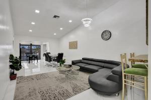 a living room with a couch and a table at The Lake House in Fort Lauderdale in Fort Lauderdale