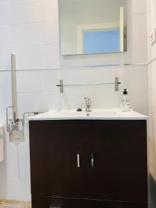 a bathroom with a sink and a mirror at Finca Vistalpas in Mogro