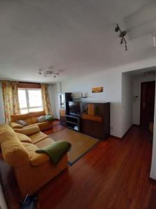 a living room with a couch and a table at Apartamento Ribeira in Ribeira