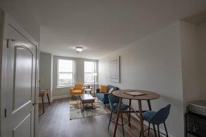 a living room with a table and chairs at Stylish 1 BR 1BA at The Inman in Champaign